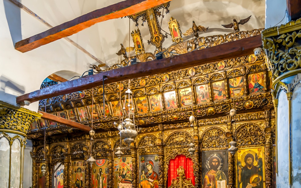 Ornate wooden iconostasis with religious paintings inside Berat Castle, Albania.