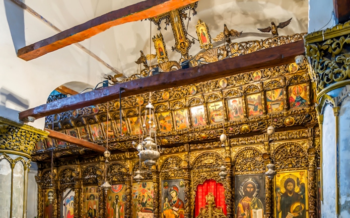 Ornate wooden iconostasis with religious paintings inside Berat Castle, Albania.