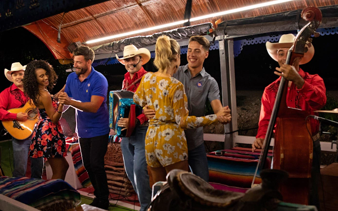 Couples dancing to live mariachi music at Xoximilco Park.