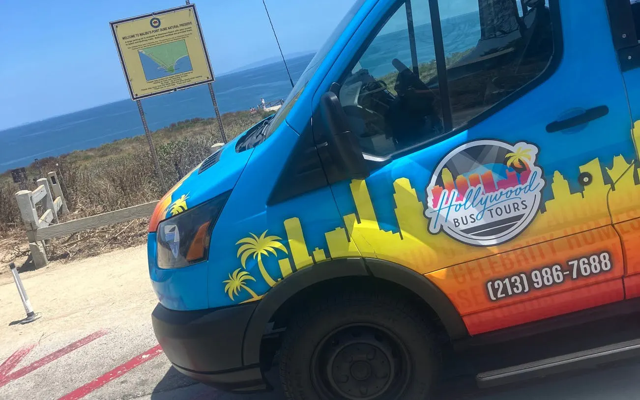 Tour bus parked near Malibu coastline on Santa Monica to Malibu open-air tour.