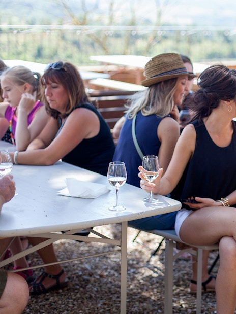 Group enjoying wine tasting outdoors in Chianti.