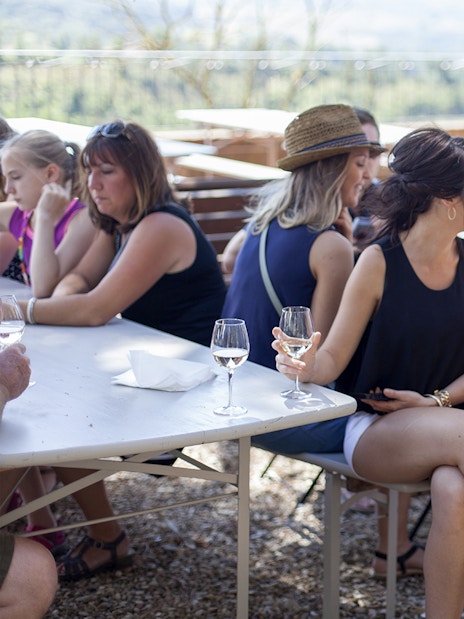 Group enjoying wine tasting outdoors in Chianti.