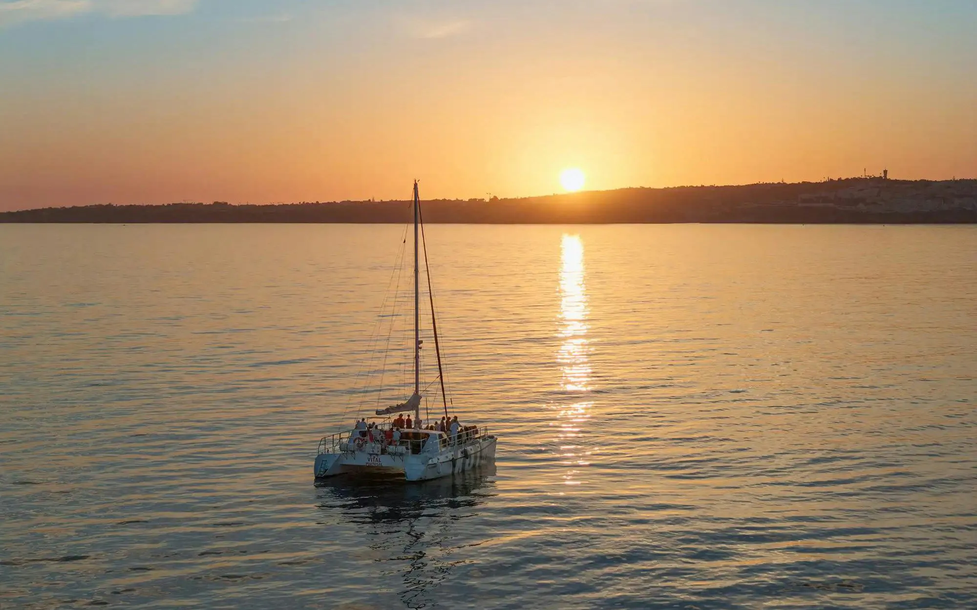 Catamaran sailing at sunset on Algarve tour from Vilamoura.