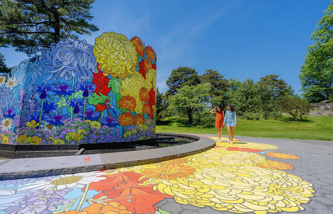 Visitors walking through the lush pathways of New York Botanical Garden.
