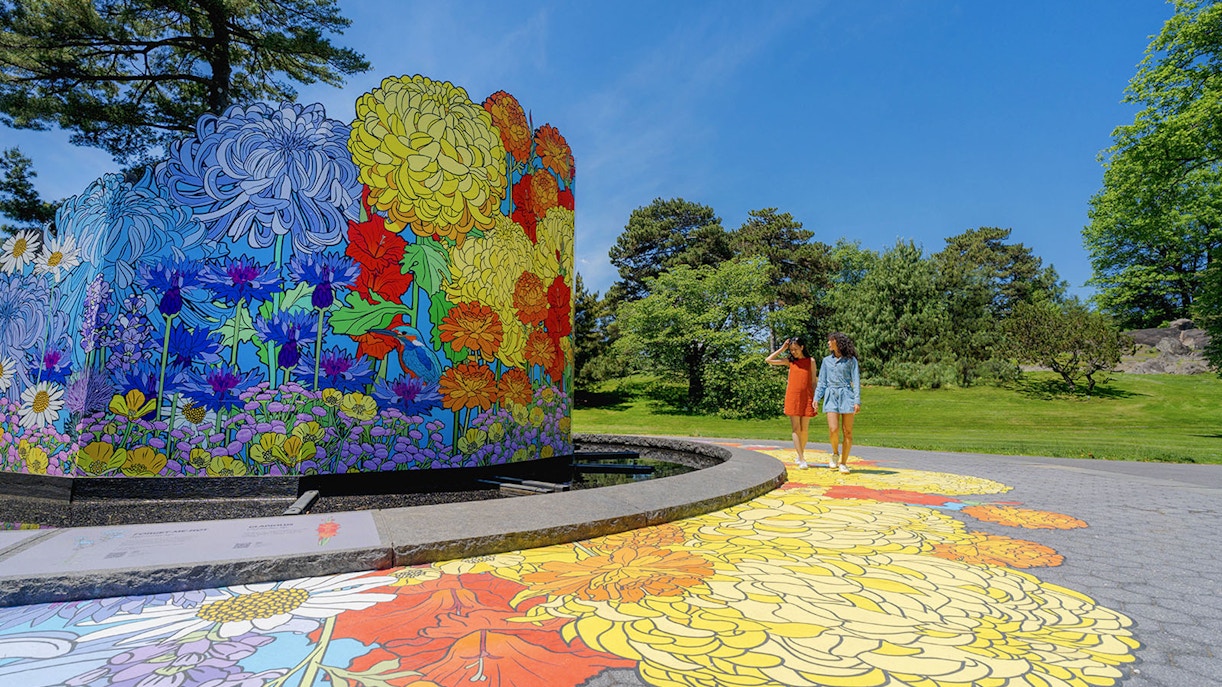 Visitors walking through the lush pathways of New York Botanical Garden.