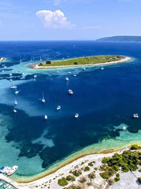 Boats anchored near islands in Blue Lagoon, Croatia, part of the Small Group 3 Islands tour.