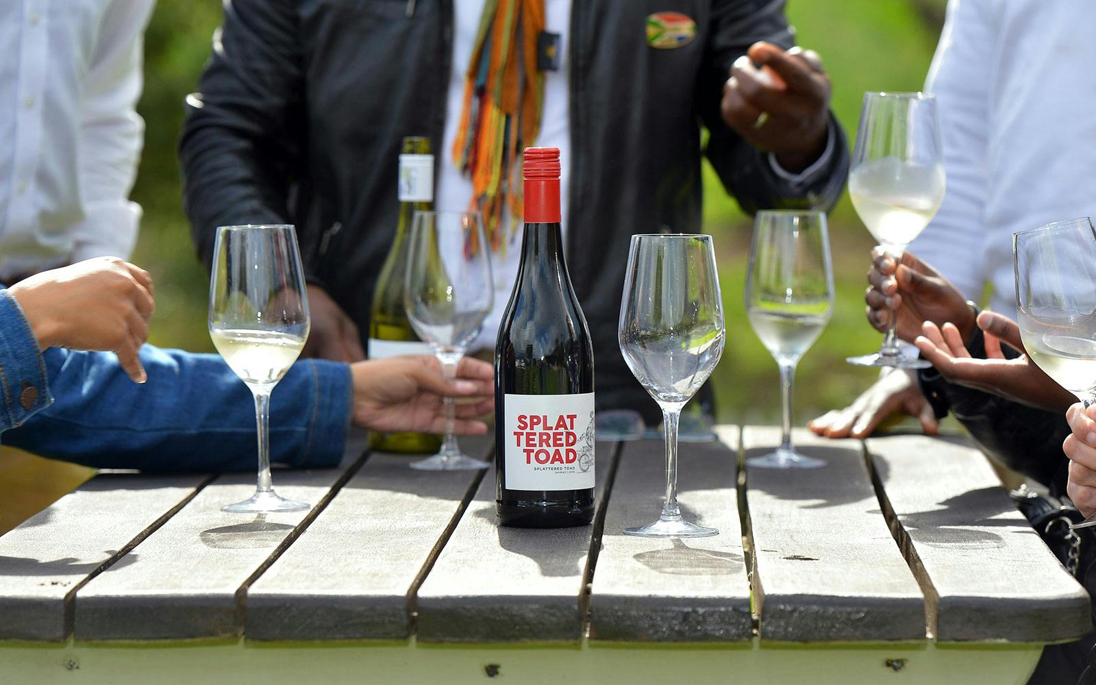 Tourists tasting wine at a table in Constantia, South Africa.