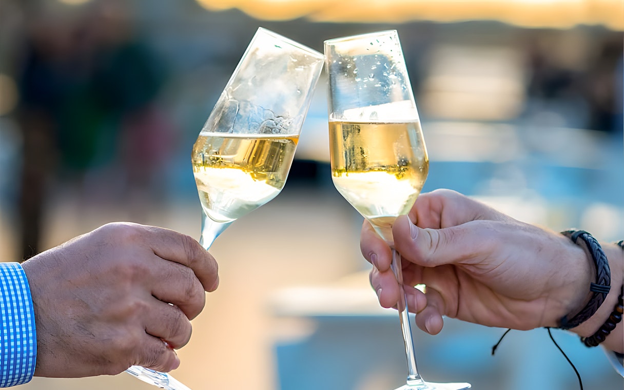 Toasting champagne glasses on Le Diamant Bleu Seine River cruise.