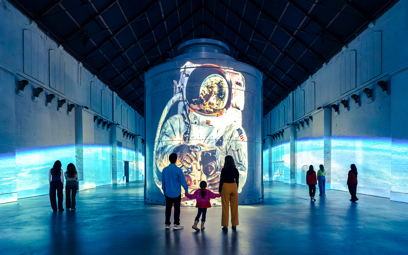 Guests viewing astronaut projection at Moonwalkers Exhibition, Fabrique des Lumières, Amsterdam.