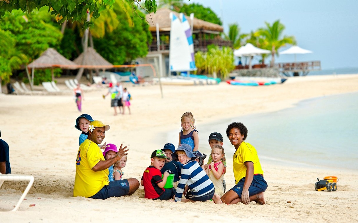 Family enjoying beach activities on Castaway Island, Fiji.