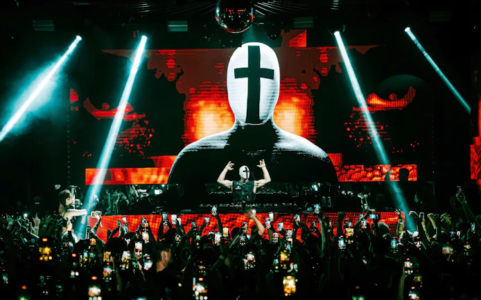 DJ performing at EPIC club after party in Prague with vibrant light show.