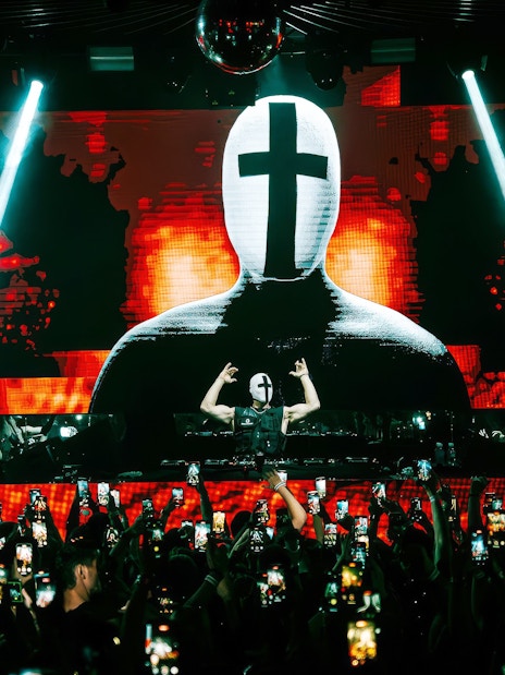 DJ performing at EPIC club after party in Prague with vibrant light show.