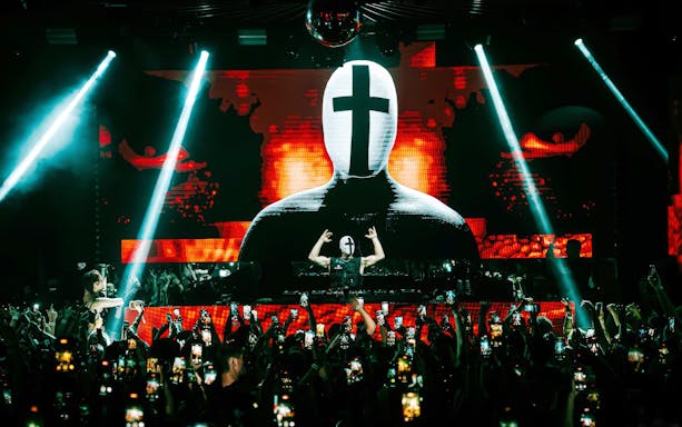 DJ performing at EPIC club after party in Prague with vibrant light show.