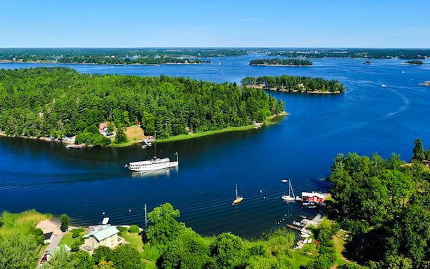 Aerial view of the Stockholm Archipelago with boats and lush green islands.