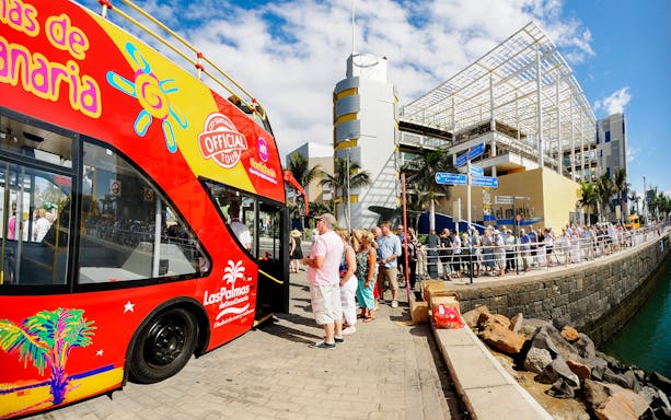 Hop-On Hop-Off bus at Las Palmas port with tourists boarding.