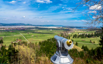Viewing scope overlooking Bavarian countryside near Neuschwanstein Castle.