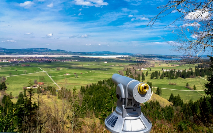 Viewing scope overlooking Bavarian countryside near Neuschwanstein Castle.