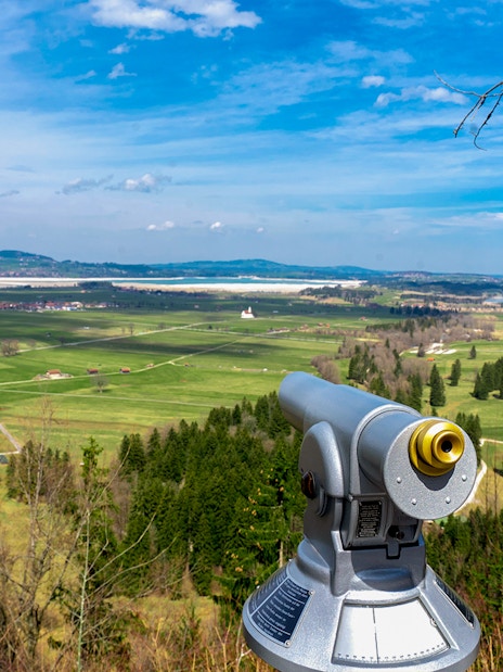 Viewing scope overlooking Bavarian countryside near Neuschwanstein Castle.