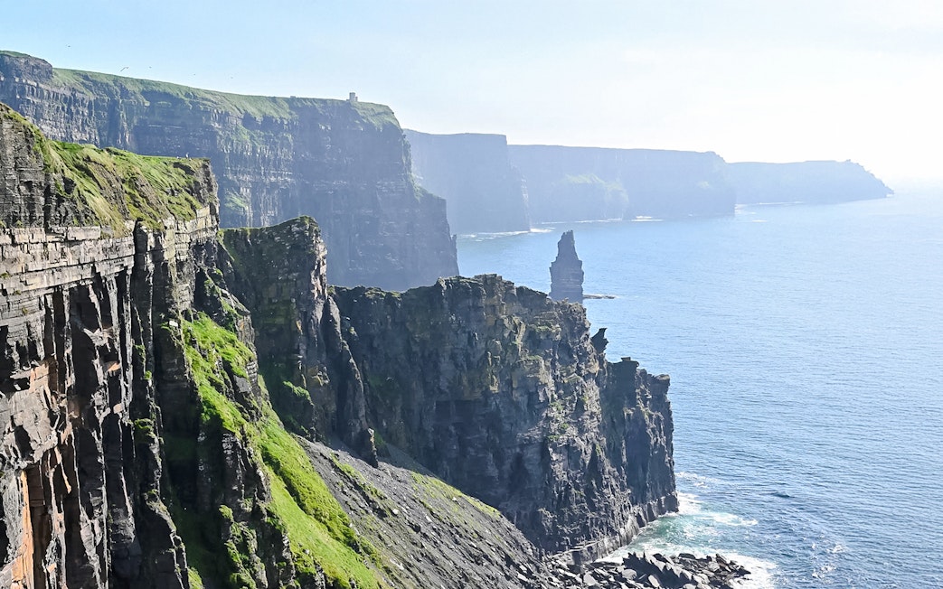 Cliffs of Moher, Ireland, with rugged cliffs and ocean view.