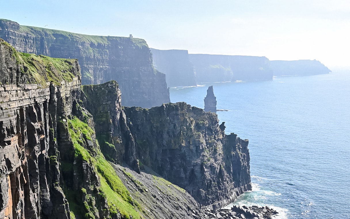 Cliffs of Moher, Ireland, with rugged cliffs and ocean view.