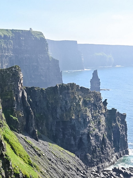 Cliffs of Moher, Ireland, with rugged cliffs and ocean view.