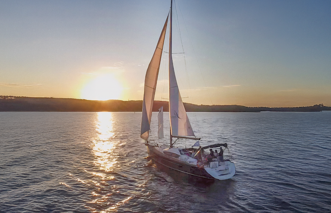 Sailing boat at sunset on a cruise from Sopot Pier, Gdansk.