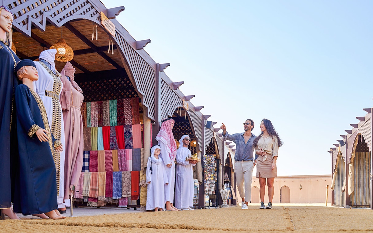 Couple exploring market stalls at Noble Camp Desert Safari.