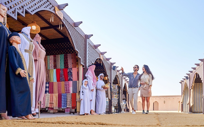 Couple exploring market stalls at Noble Camp Desert Safari.
