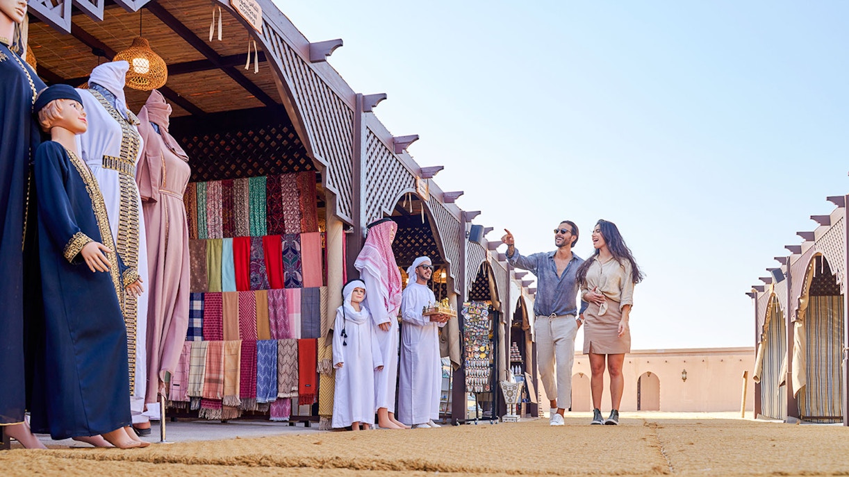 Couple exploring market stalls at Noble Camp Desert Safari.