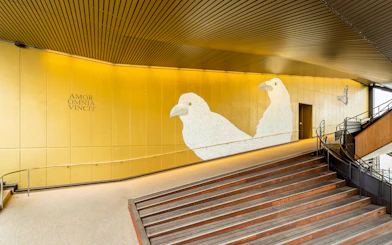 Hiroshima Orizuru Tower interior with bird mural and staircase.