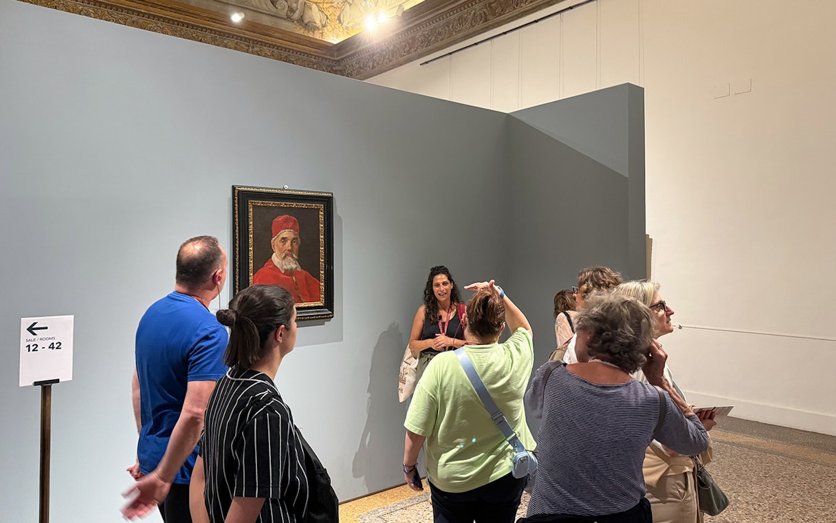Visitors viewing a portrait during a guided tour inside Palazzo Barberini.