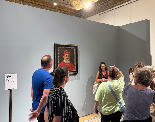 Visitors viewing a portrait during a guided tour inside Palazzo Barberini.