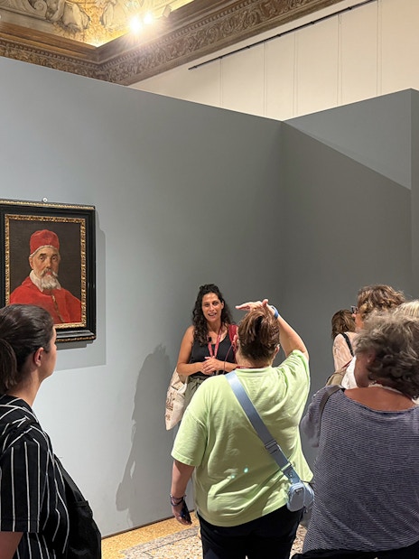 Visitors viewing a portrait during a guided tour inside Palazzo Barberini.