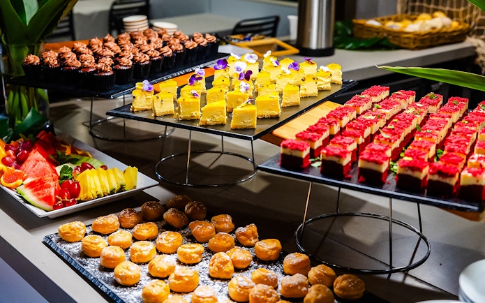Buffet spread with desserts and fruit on Gold Coast sightseeing cruise.