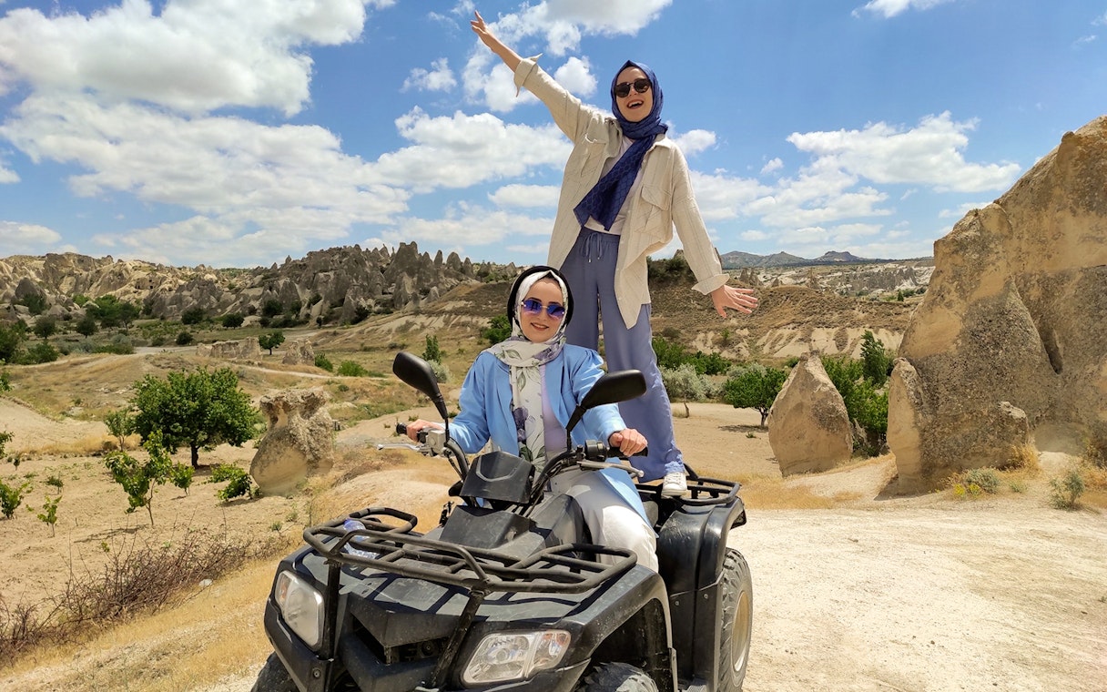Cappadocia ATV tour with two people enjoying the rocky landscape.
