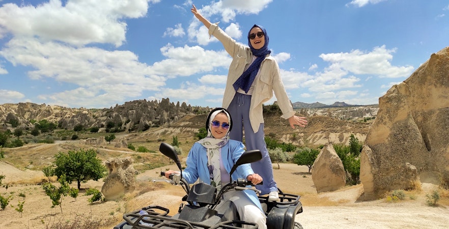 Cappadocia ATV tour with two people enjoying the rocky landscape.