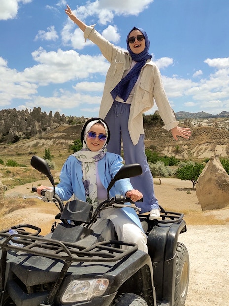 Cappadocia ATV tour with two people enjoying the rocky landscape.