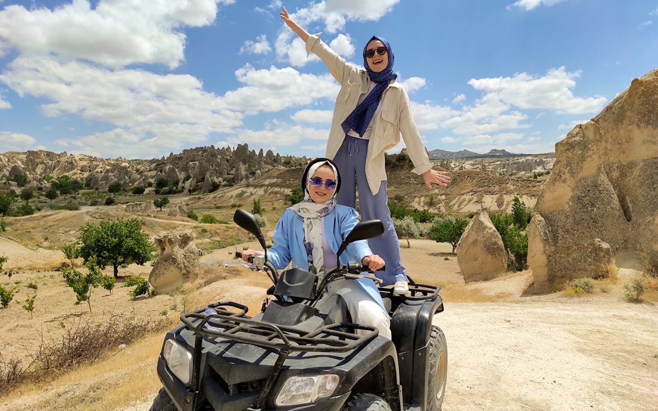 Cappadocia ATV tour with two people enjoying the rocky landscape.