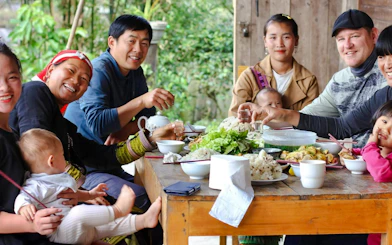 Group enjoying traditional meal during Sapa 1 Day Tour in Lao Chai, Ta Van, Giang Ta Chai.
