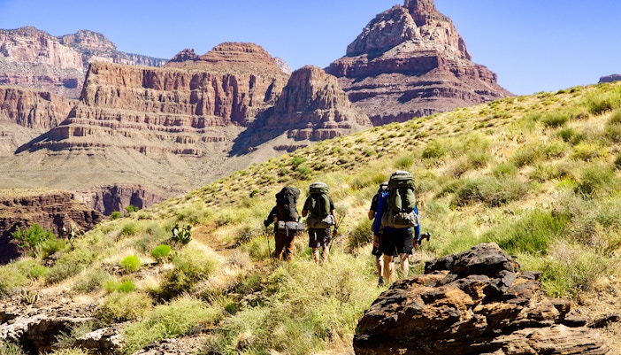 Hikers on Grandview Trail approaching Colorado River in Grand Canyon.