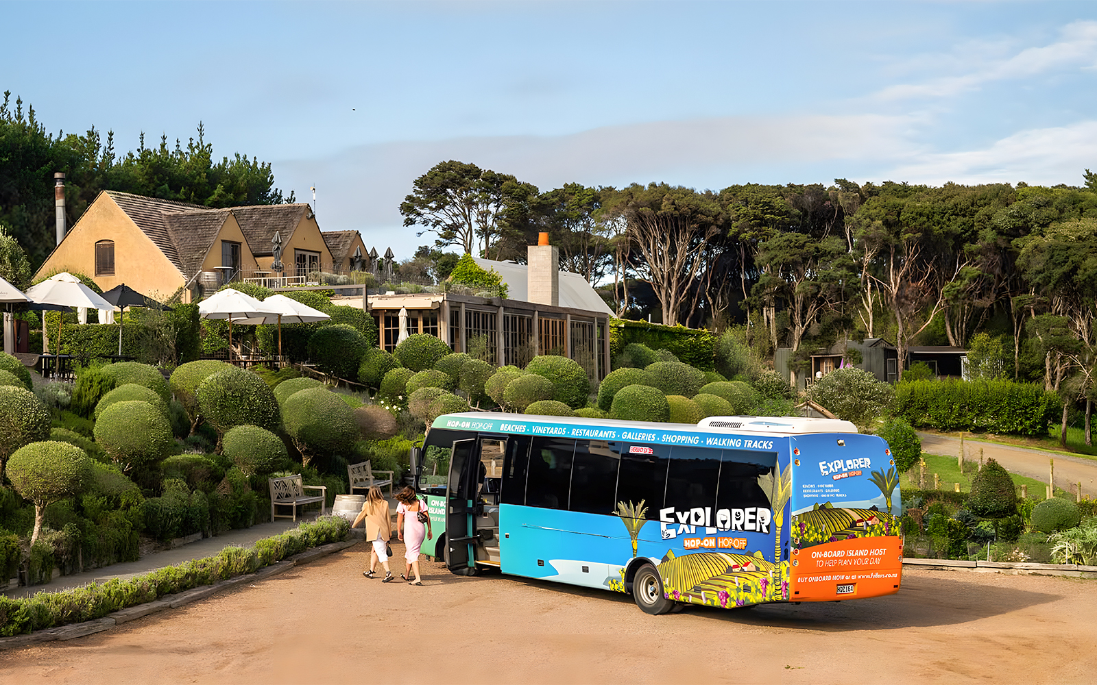 Waiheke Island hop on hop off tour bus near vineyard estate.