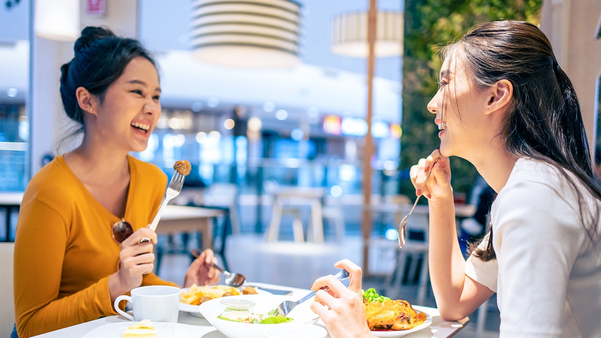women enjoying food from food. court
