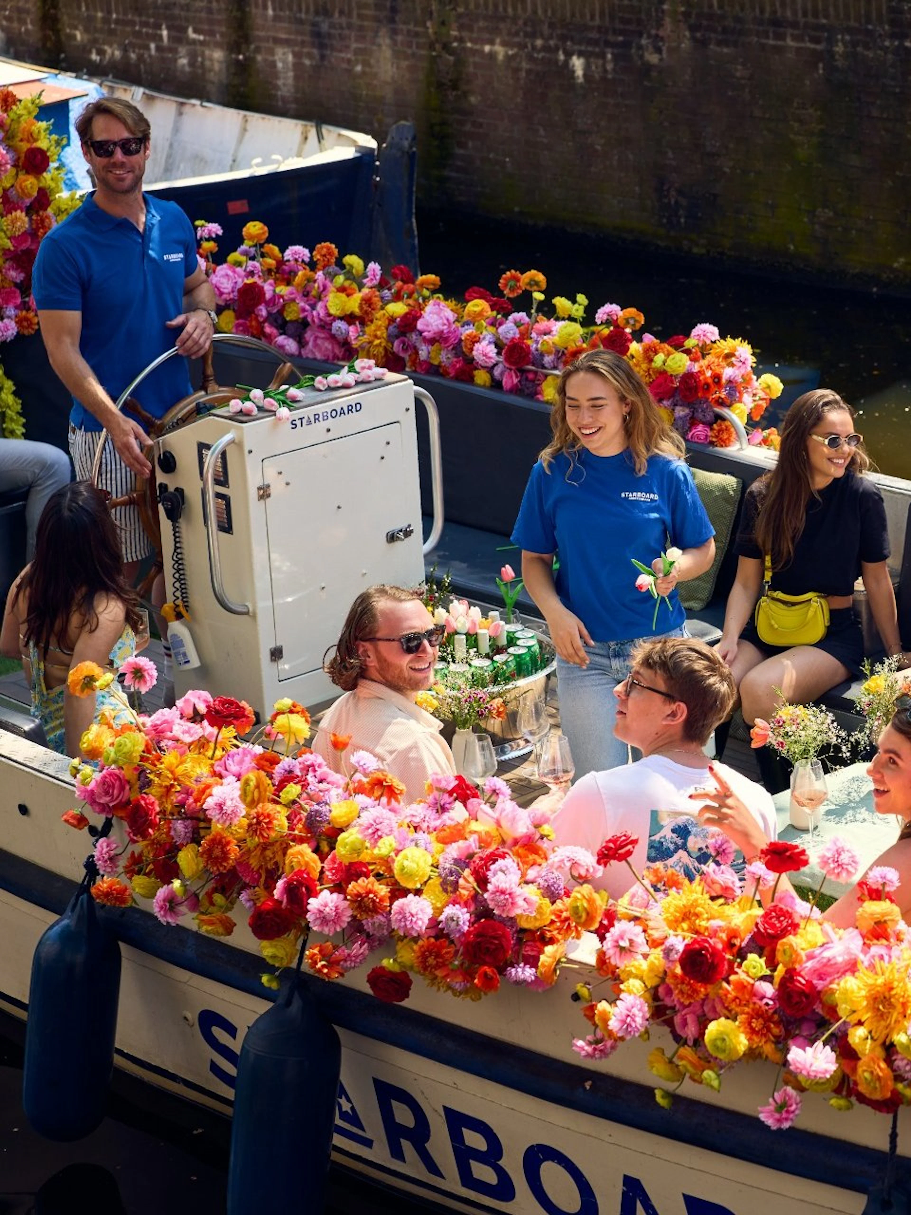 Group enjoying a City Highlights Cruise on a flower-adorned luxury boat.