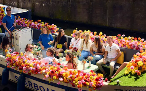 Group enjoying a City Highlights Cruise on a flower-adorned luxury boat.