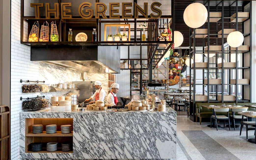 Chefs preparing dishes at live cooking stations, Gastronomy Buffet Dinner, Dubai.