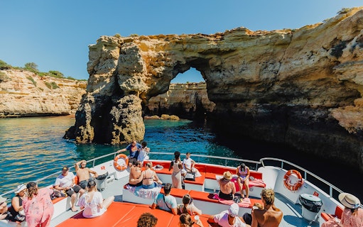 Sightseeing boat approaching Benagil Caves on Algarve coast during 3-hour cruise from Albufeira.