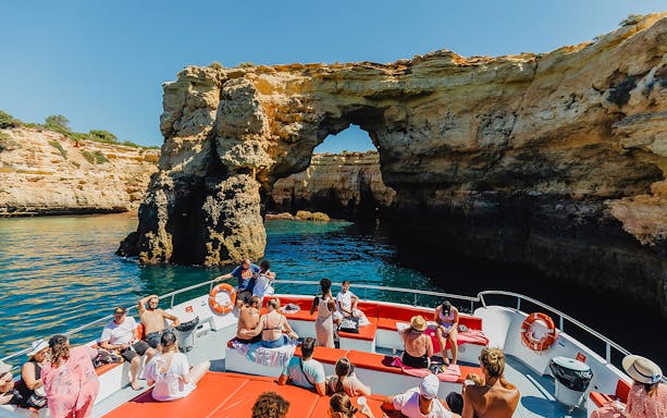 Sightseeing boat approaching Benagil Caves on Algarve coast during 3-hour cruise from Albufeira.
