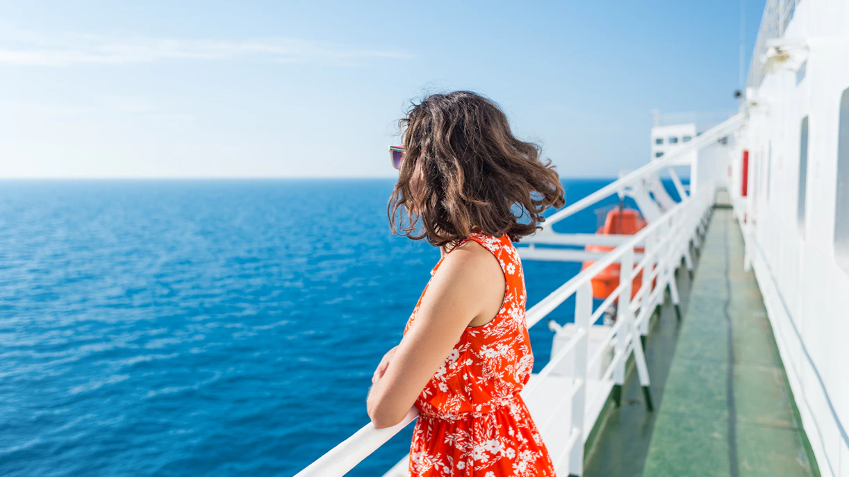 Woman enjoying ocean view from ferry deck.