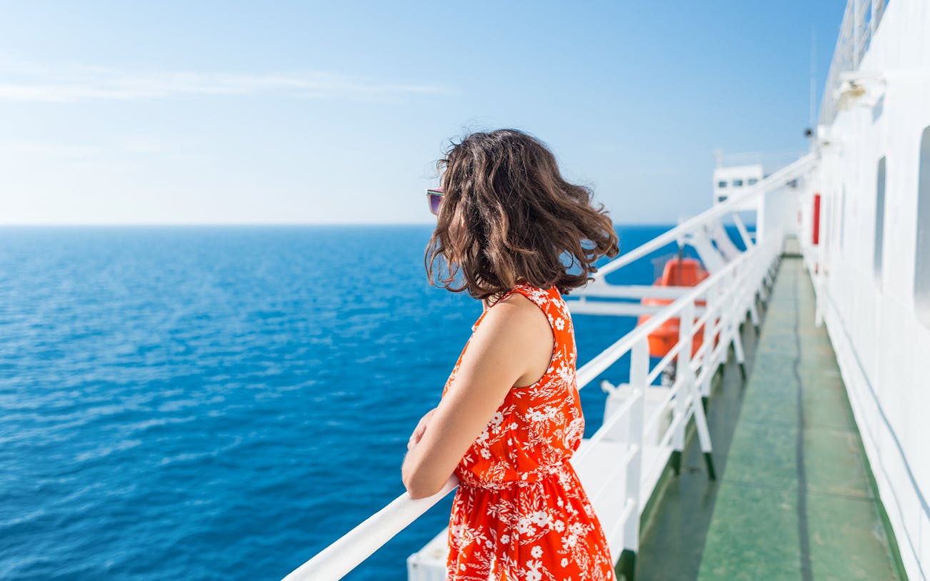 Woman enjoying ocean view from ferry deck.