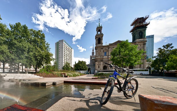 Bicycles parked near a historic building in Warsaw during a 3-hour bike tour.